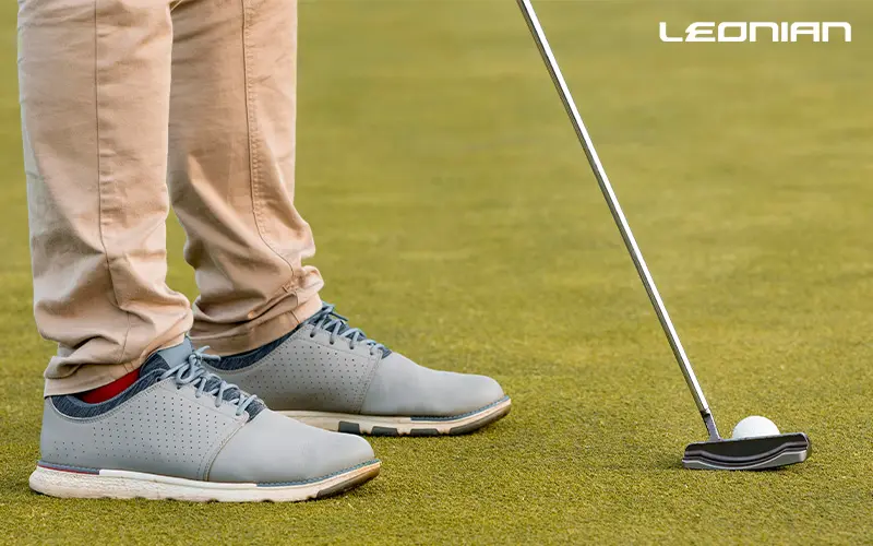 Golfer wearing golf shoes, getting ready to putt.